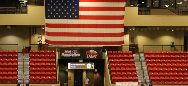 Showdown arena seating beneath a large American flag