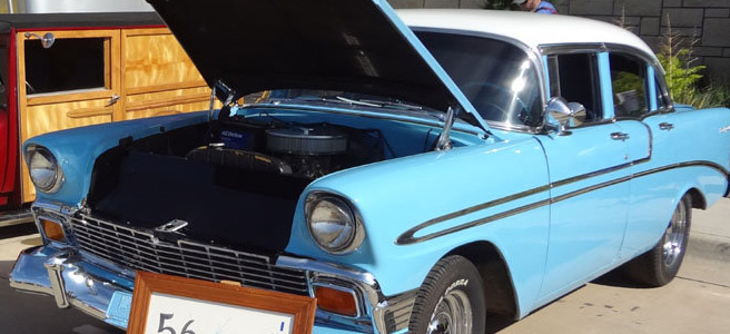 Blue classic Chevrolet displayed with its hood open